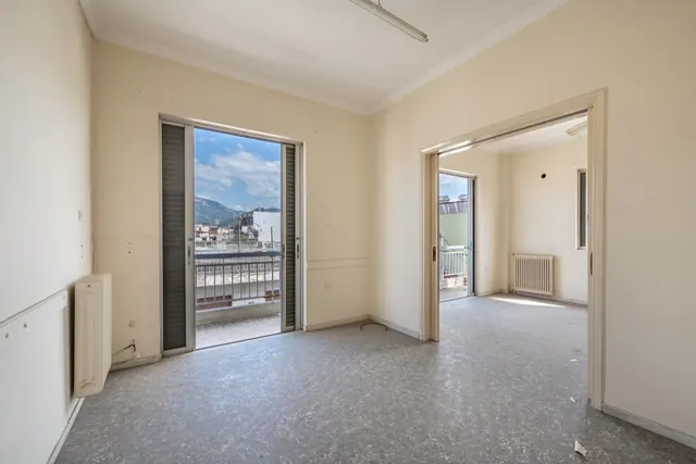 Existing interior before renovation: room with balcony door and mountain view
