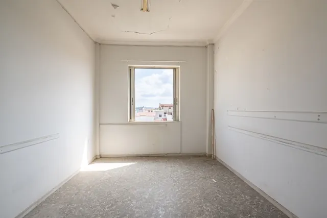 Existing interior before renovation: bright room with window