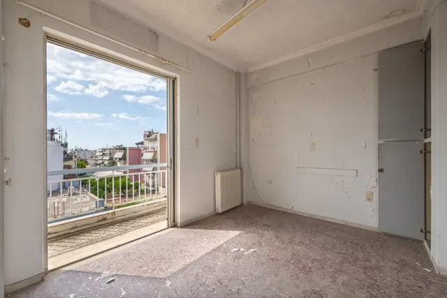 Existing interior before renovation: room opening onto a balcony