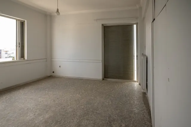 Existing interior before renovation: empty room with window