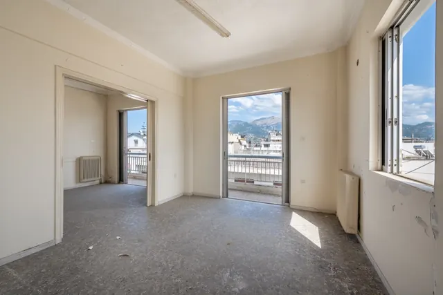 Existing interior before renovation: corner room with two windows