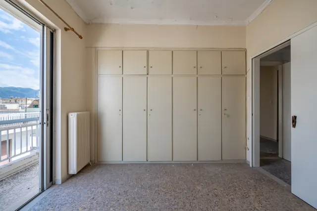 Existing interior before renovation: room with wardrobes and balcony